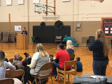 CWO Morgan Ferrer addresses students at a veterans day event assembly at Lowman Hill elementary Topeka on 14 Nov 2019 