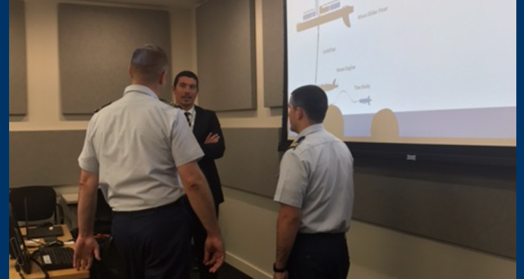 Two Coastguardsmen discuss unmanned surface vehicle capabilities with an industry representative during a technology demonstration hosted by the Innovation Council at Coast Guard headquarters in Washington, D.C., Oct. 19, 2017.