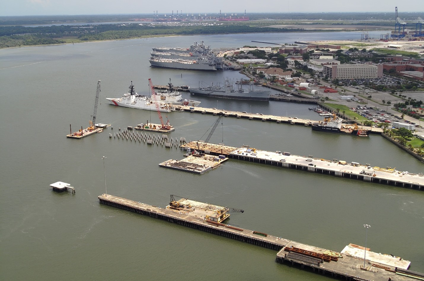 Reconstruction of Pier November (second from the bottom) continues July 23, 2025, at Base Charleston in North Charleston, South Carolina. The Coast Guard used funding made available under the One Big Beautiful Bill Act to modify an existing contract to remove submerged pilings in the vicinity of the piers to facilitate construction of new and modernized facilities to support Coast Guard major cutter operations. U.S. Coast Guard photo. Reconstruction of Pier November (second from the bottom) continues July 23, 2025, at Base Charleston in North Charleston, South Carolina. The Coast Guard used funding made available under the One Big Beautiful Bill Act to modify an existing contract to remove submerged pilings in the vicinity of the piers to facilitate construction of new and modernized facilities to support Coast Guard major cutter operations. U.S. Coast Guard photo.