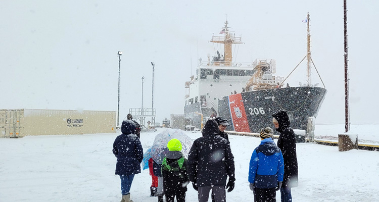 Families of Coast Guard Cutter Spar’s crew watch the seagoing buoy tender’s arrival at its new homeport of Duluth
