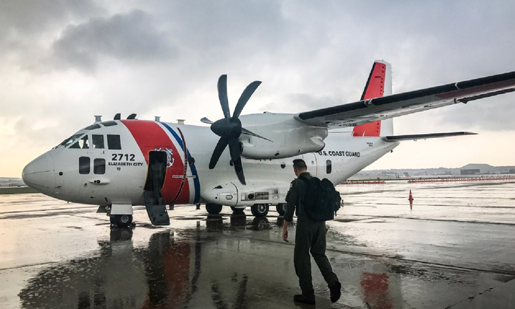 A Coast Guardsman prepares to board a C-27J Spartan
