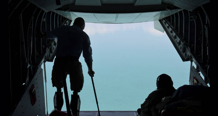 Rep. Brian Mast of Florida’s 18th District looks out the tail of an Air Station Miami HC-144