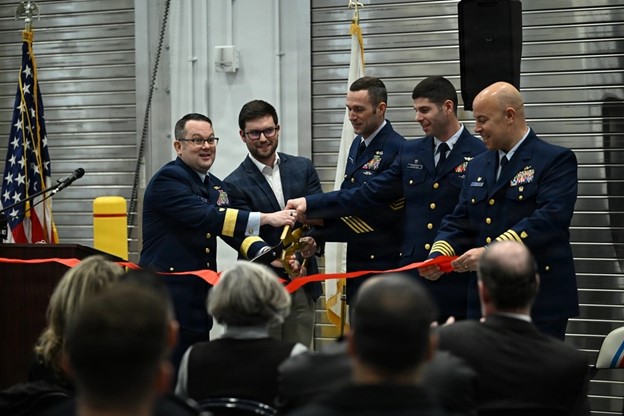 Coast Guard Rear Admiral Russell E. Dash, commander of the Great Lakes District, and others in the official party, celebrate the ribbon cutting for the newly built Station and Aids to Navigation Team Buffalo building on January 12, 2026.