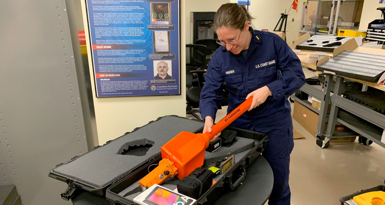Ensign Jennifer Hansen prepares a technology go-kit 
