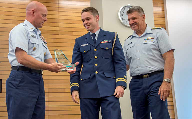 Master Chief Petty Officer Jason Vanderhaden presents the Capt. Niels P. Thomsen Innovation Award in the Science or Technology category to Lt. Jake Taylor 