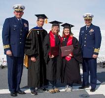 Photo of Coast Guardsmen in graduation gowns