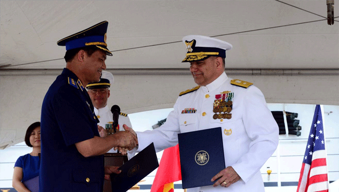 Lt. Gen. Nguyen Quang Dam, commandant of the Vietnamese coast guard, and Rear Adm. Michael J. Haycock